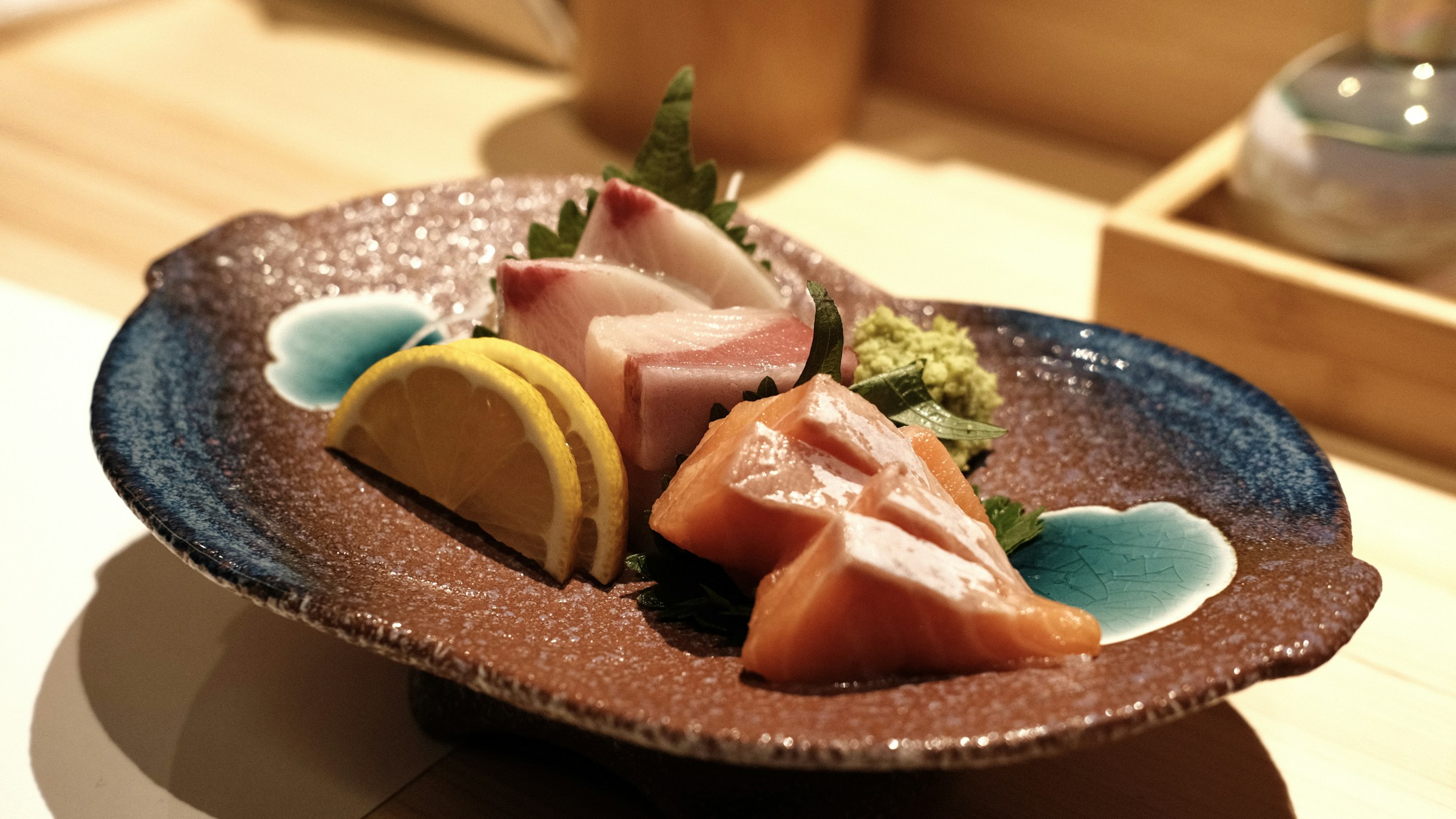 Sashimi and sushi arrangement on a dark wooden board